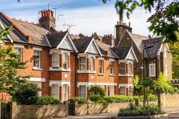 A street of traditional terraced houses, on a quiet leafy street in East London.